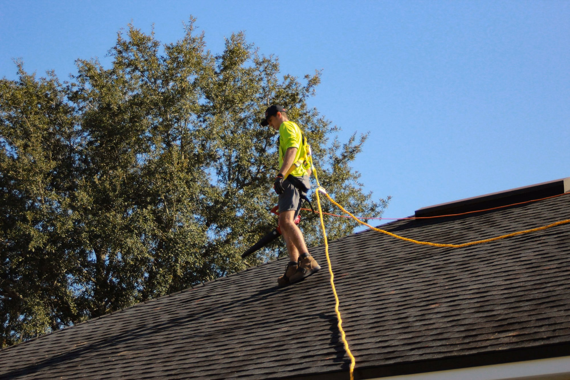 Texas Vets Roofing technician walking a shingle roof during inspection